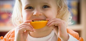 Health & Wellbeing Girl eating orange