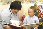 Child with nurse reading Child with nurse reading