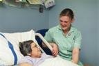 Female patient smiling at nurse Female patient smiling at nurse